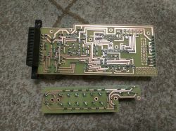 Two Schneider DCS8070WR PCB boards lying on a patterned carpet