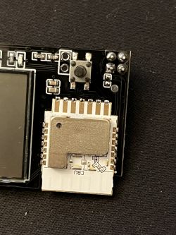 Electronic Module with Button and CBU Marking Image of an electronic module with a visible button and CBU marking.