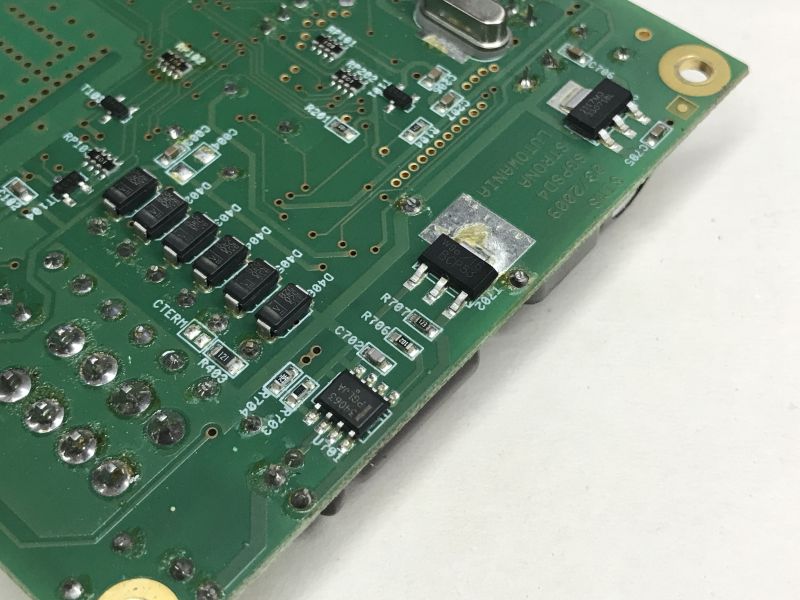 Close-up of green PCB underside with SMD components and SGPSD4 marking