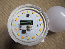 View of the interior of an LED bulb with visible electronic circuit and LED diodes.