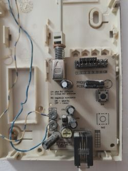 Unconnected Intercom Interior Inside of an intercom housing with visible electronics and wires.