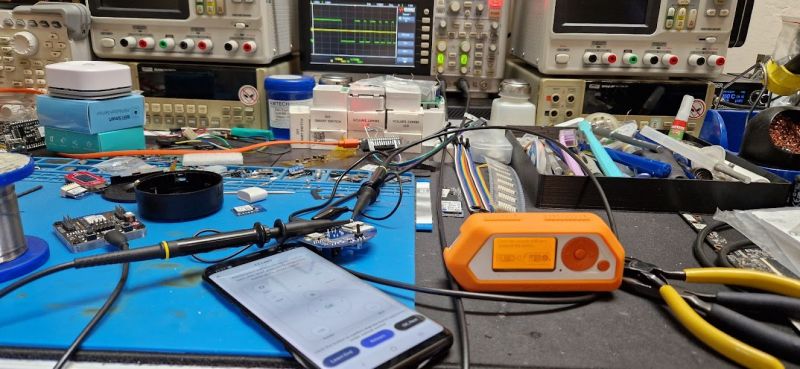 Working with IR Signals in a Laboratory Laboratory with electronic devices, an oscilloscope, and a Flipper Zero on the table.