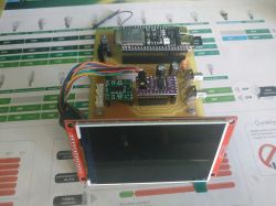 Prototype board with an ESP32 module, wiring, and a large LCD screen on a red PCB.