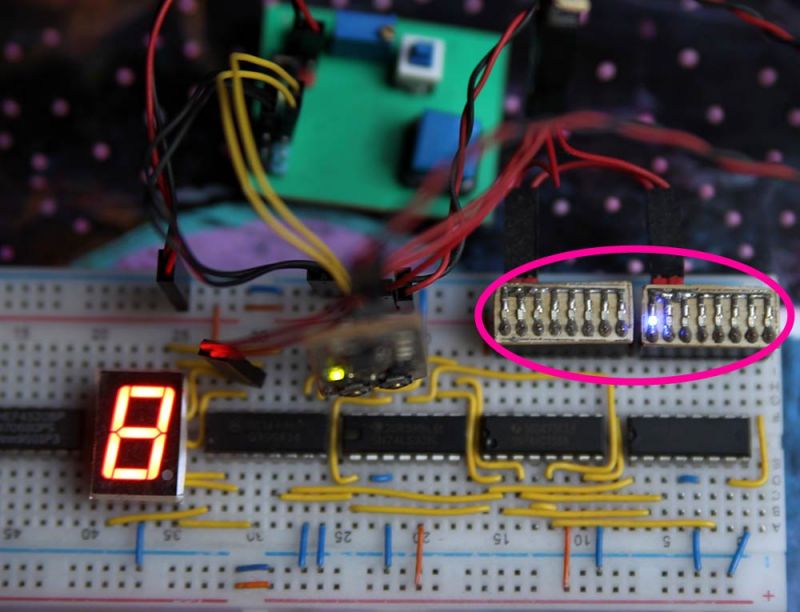 Breadboard prototype with a 7-segment display and marked I2C pins.