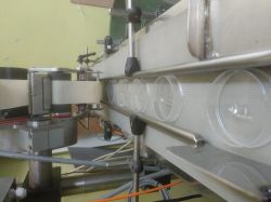 Linia produkcyjna z etykietami aplikowanymi na plastikowe pudełka.