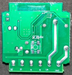 Close-up view of a green printed circuit board from a Wi-Fi smart switch.