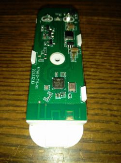 Board with BL602L10 Chip Electronic board with a BL602L10 chip on a wooden surface.