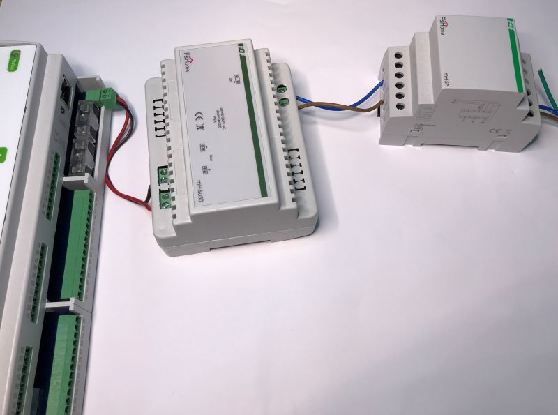 View of building automation modules connected with wires, placed on a white background.