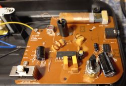 Printed circuit board with electronic components, including capacitors and diodes.