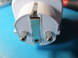 Close-up of EU Electrical Plug Prongs Close-up view of EU electrical plug prongs on a blue background.