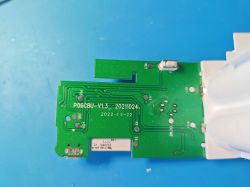 Close-up of a green circuit board with markings P06CBU-V1.3 and date 2022-12-22 on a blue background.