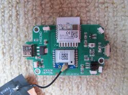 Electronic board with components including a module marked with QR codes.