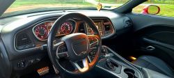 Interior of a Dodge car, view of the steering wheel, dashboard, and center console.