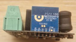 Electronic module with blue PCB and green terminal block in close-up