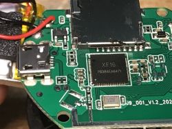 Close-up of a circuit board with an XF16 chip and a USB port.