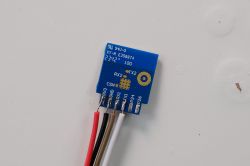 Electronic Module with Wires Close-up of a blue electronic module with attached wires.