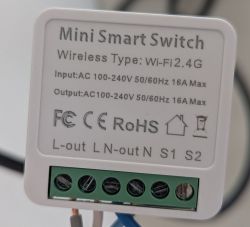 Mini Smart Switch with Wi-Fi and terminal labels Mini smart switch with tech label and terminal connectors visible
