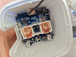 Interior of an electronic device with visible components on a circuit board.