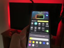 Smartphone with Govee app and red LED backlight behind TV