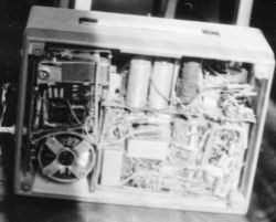 Black-and-white photo of the inside of an electronic device with wires and components