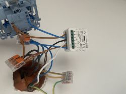 Roller shutter controller wired in an electrical box with visible terminal connectors.