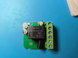 Close-up of a green PCB with a JQX-105F relay and several electronic components.