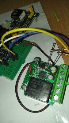 Close-up of a prototype electronic circuit with wires and pins connected to a PCB.