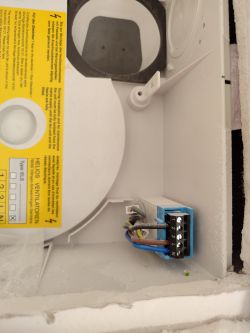View of the interior of a device with connected cables in a Helios electrical panel.