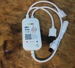 Appio Strip 7331 Controller with Attached Cables RGB LED strip controller with informational sticker and attached cables.