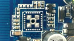 Macro photo of a PCB fragment with SMD components and an empty spot for an integrated circuit.