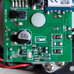 Close-up of a PCB with SMD parts, a 220 µF 10V capacitor, and visible solder marks