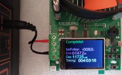 Battery capacity tester display showing “Complete!” with results 147.2 Wh and 11725 mAh