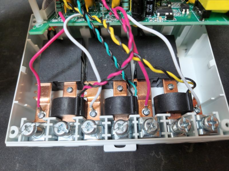 Interior of a Three-Phase Energy Meter Image of the interior of a three-phase energy meter, showing wires connected to terminals.