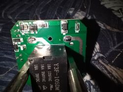 Close-up of a circuit board with a Y3F-105DM relay and several SMD electronic components.