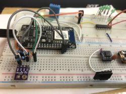A breadboard with connected electronic components, such as sensors and modules.