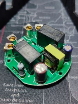 Circuit Board with Relays and Capacitors Circular circuit board with electronic components, including relays and capacitors.