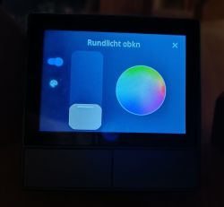 Touchscreen display showing a lighting control interface with a color selection option.