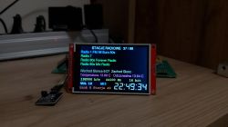 LCD screen with radio station list, audio data, and large digital clock
