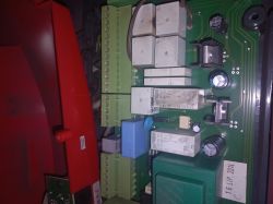 Mainboard of Defro duo furnace controller KP1V2 with visible electrolytic capacitors and relays.