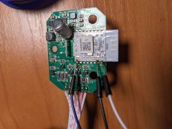 Electronic module with RX, TX, and GND wires connected on a wooden table.