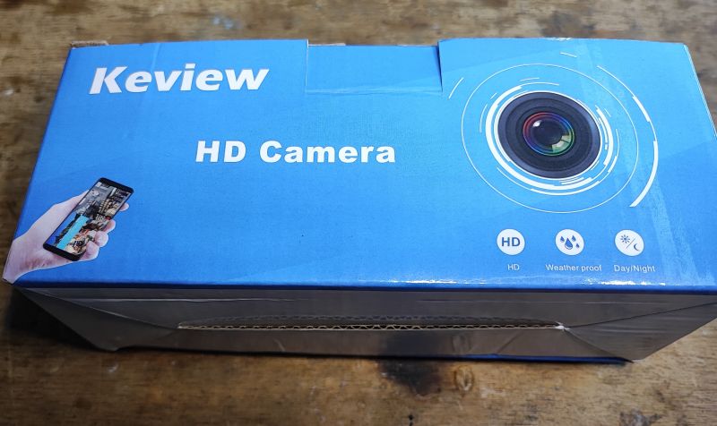 Niebieskie pudełko kamery IP Keview HD z nadrukowanym obiektywem i ikonami.