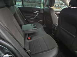 Rear car seat with armrest and cup holders extended.