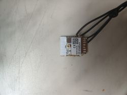 Electronic module with four wires on a light background.