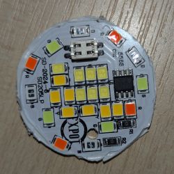 LED Circuit Board with Multicolored LEDs LED circuit board with LEDs in various colors on a wooden surface.