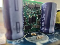 Close-up of a circuit board with capacitors and integrated circuits.