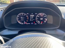 Car digital instrument cluster with tachometer, speedometer, and a message on the center display