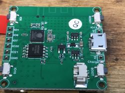 Close-up of a PCB with electronic components, including a micro USB socket, integrated circuits, and I/O connectors.