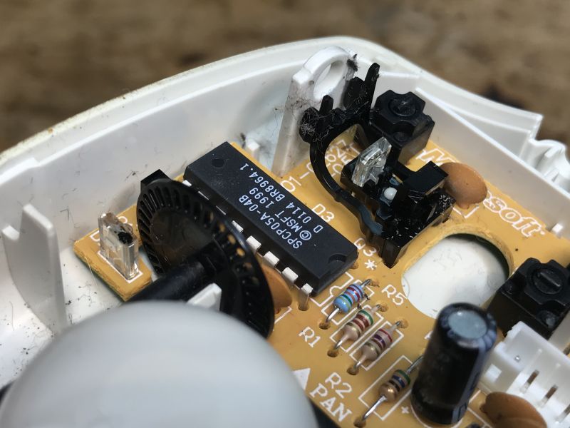 Interior of a Ball Mouse with SPCP05A-04B Chip The interior of an old ball mouse with a close-up on the SPCP05A-04B chip.