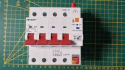 Tuya DIN 4P 1-63A Device with WiFi Tuya DIN 4P 1-63A device with WiFi features on a green measurement mat.