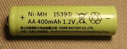 AA Ni-MH 400mAh 1.2V battery on a fabric background.